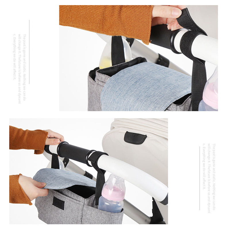 Gray textured fabric stroller organizer bag with multi storage pockets featuring black straps and a front pocket holding a pink bottle.
