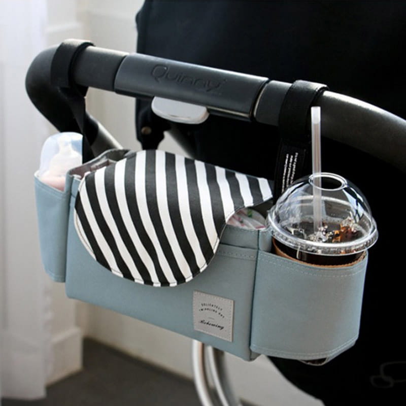 Light blue stroller organizer bag with multi storage pockets featuring a black and white striped fabric pocket and a clear cup holder.