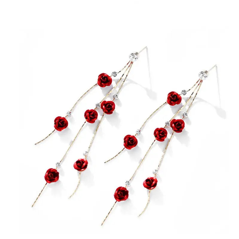 Elegant red rose tassel drop earrings featuring silver-toned chains with rhinestones and pearl accents.