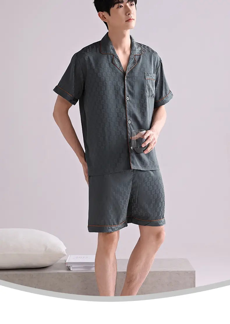 men’s ice silk pajama set in dark gray with a subtle repeating pattern and contrasting orange stitching designed as lightweight summer sleepwear.
