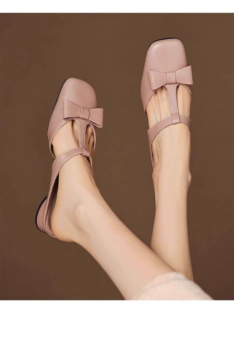 pastel pink leather mule flats for women featuring a bow detail on the closed toe front.