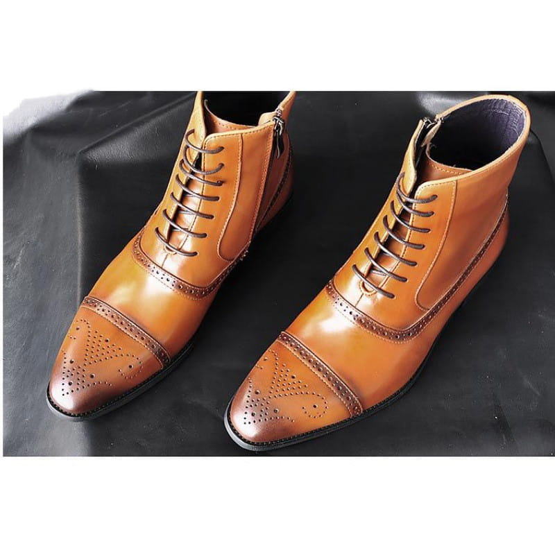 Pair of tan leather men’s winter boots brogue ankle shoes with dark laces and an inner side zipper designed for warmth and comfort.