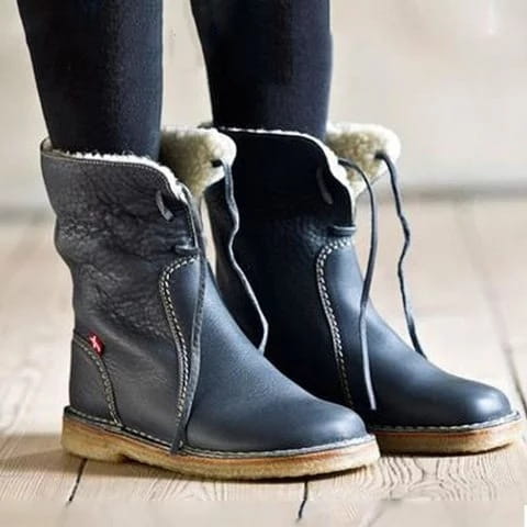 women’s shearling lined leather martin boots in dark gray with fluffy beige lining and wooden soles.