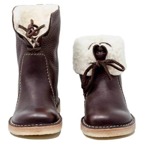 Dark brown leather women’s martin boots with white shearling lining and matching laces.