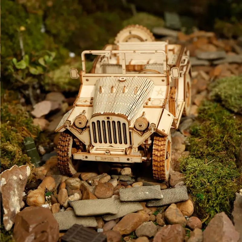 A detailed wooden model of a vintage-style jeep crafted with light-colored wood featuring intricate paneling and chrome-like accents as part of a 3d wooden train puzzle diy mechanical model kit.