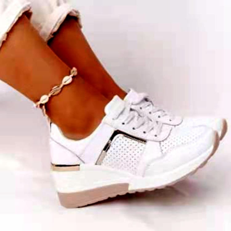 White platform sneakers with perforated mesh panels and a contrasting beige wedge sole designed for casual wear.