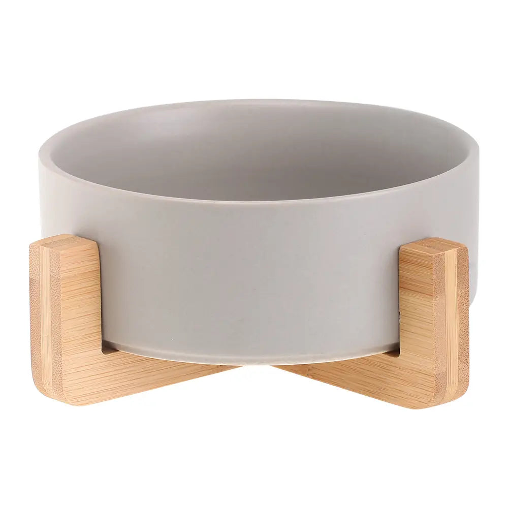 Gray ceramic double pet bowl with light wood bamboo stand for feeding pets.