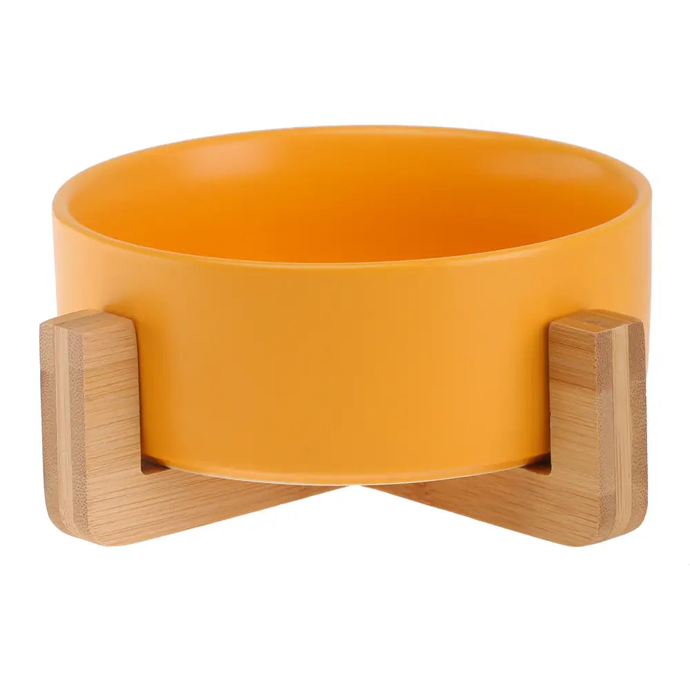 Vibrant orange ceramic double pet bowl with sleek modern design supported by two light-colored bamboo stands.