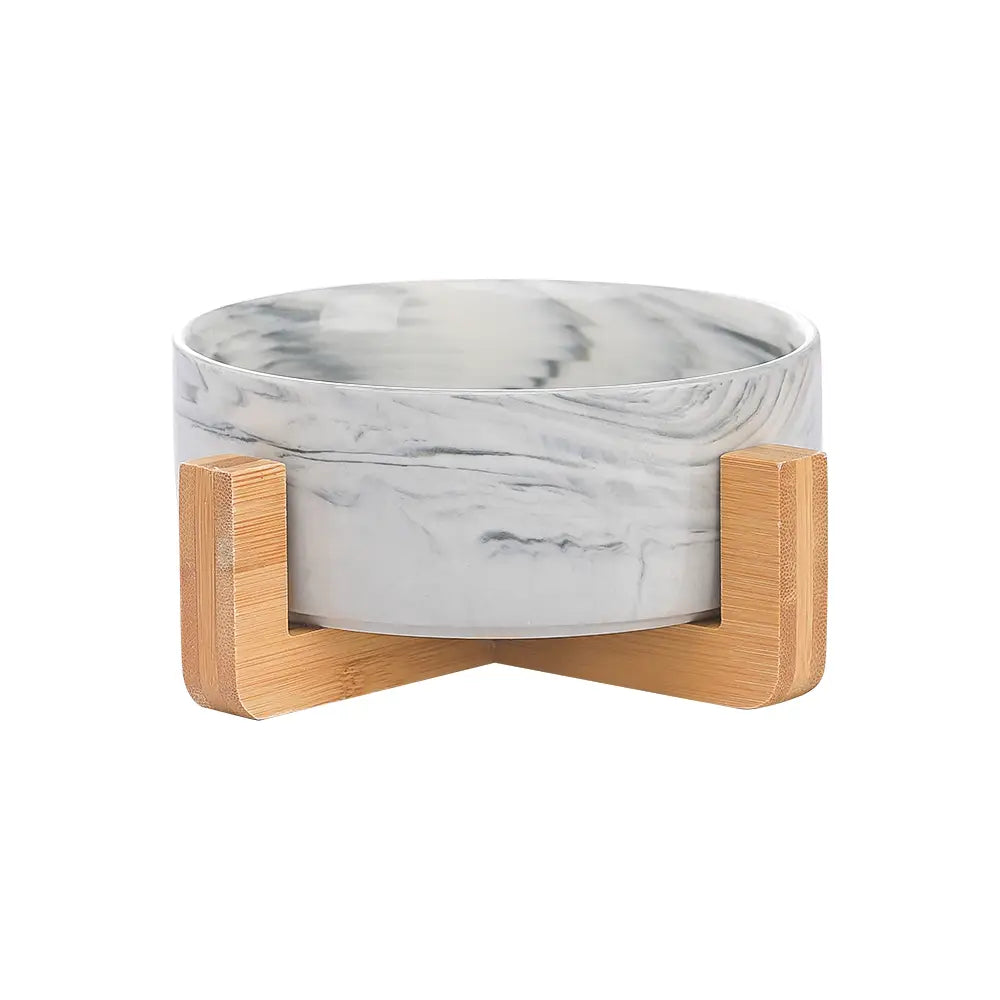 ceramic double pet bowl featuring white and gray marble-patterned ceramic bowls resting on a light wood bamboo stand.