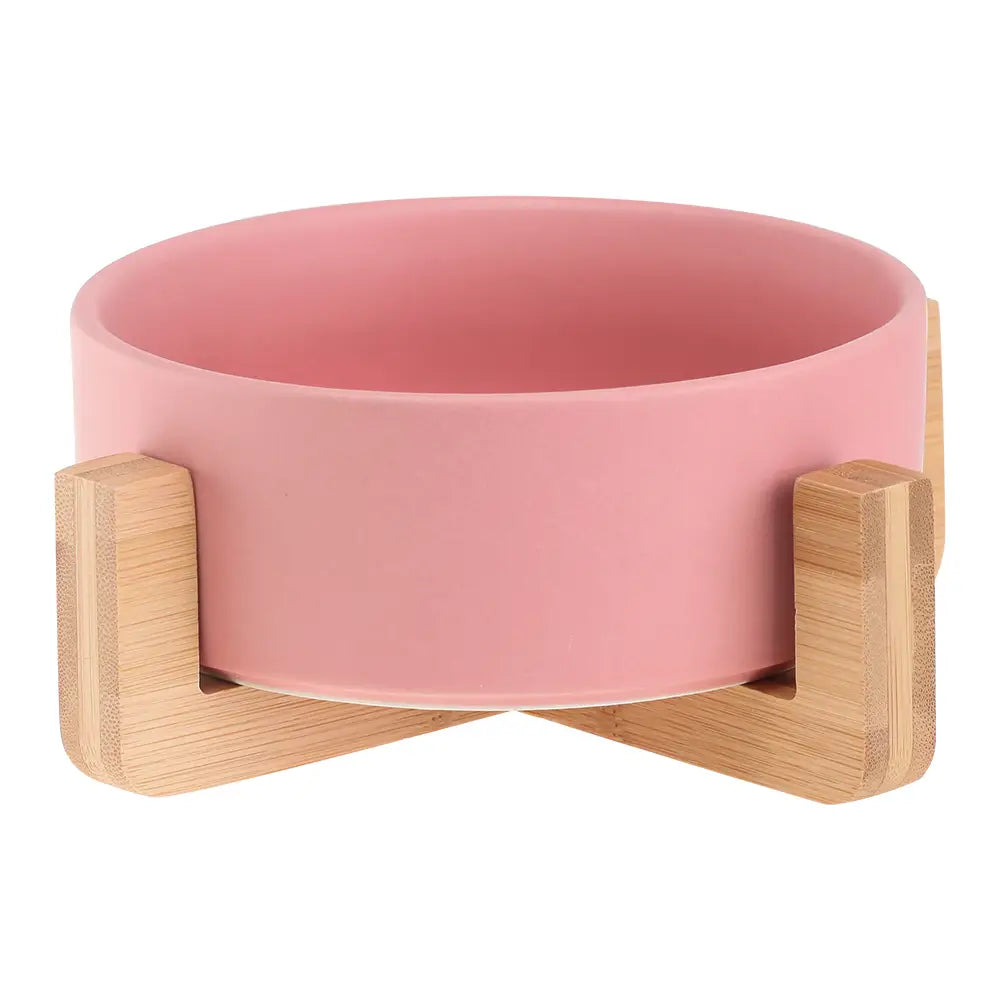 pink ceramic pet bowl with a natural wood stand in a ceramic double pet bowl with wood stand product designed for feeding pets