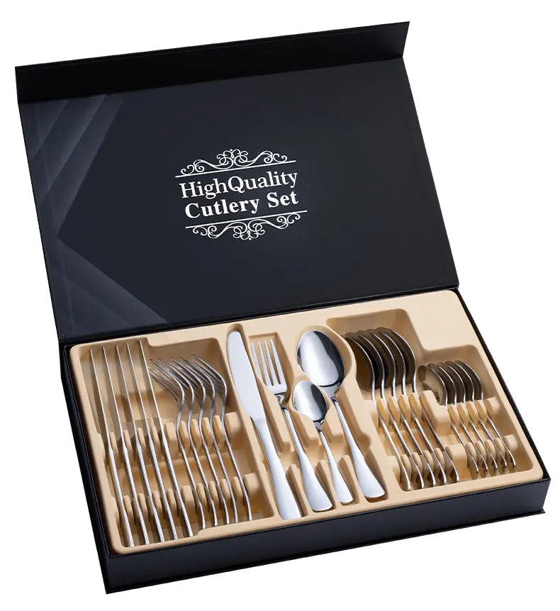 Shiny stainless steel cutlery set with mirror finish displayed in a black gift box with cream-colored interior compartments.