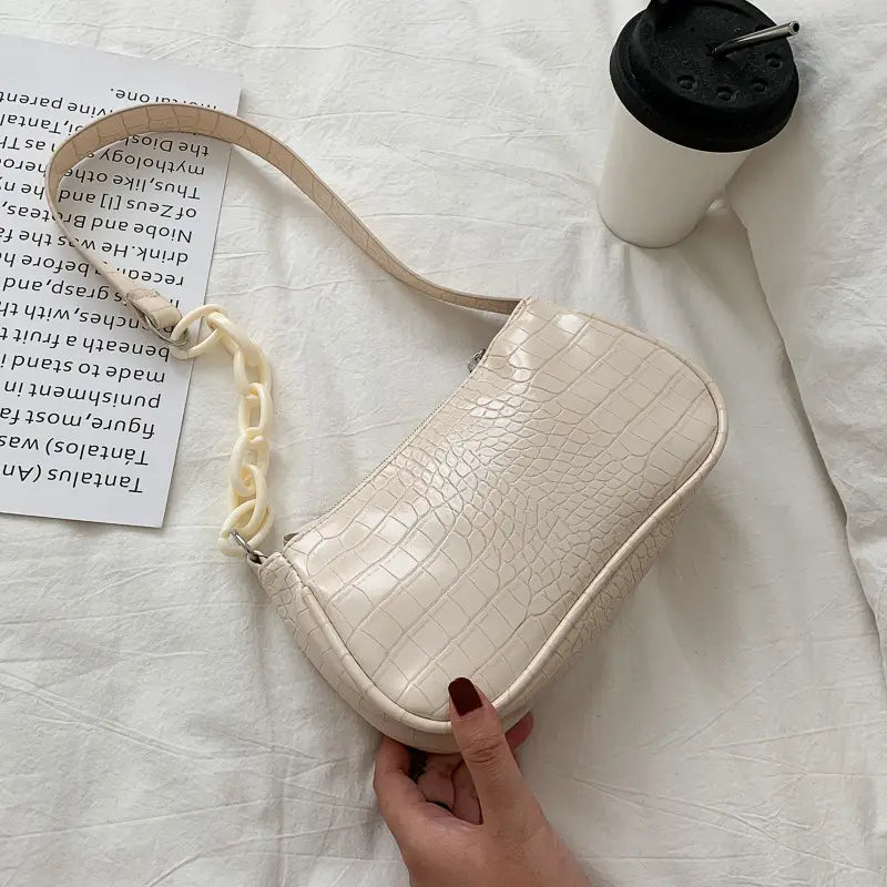 Cream-colored croc embossed chain shoulder bag for women featuring a matching chain strap and textured leather material.