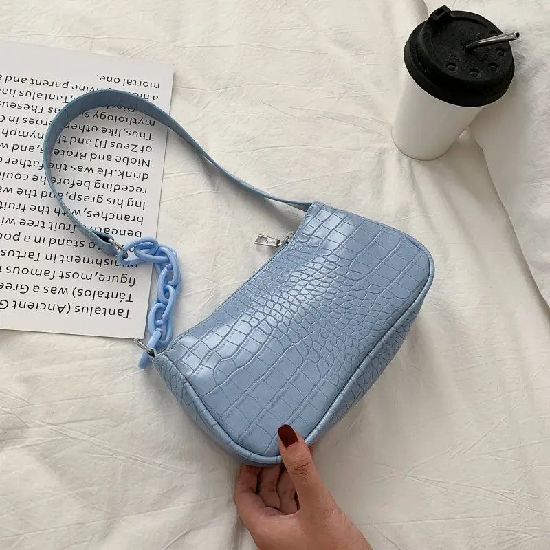 Light blue croc embossed mini shoulder bag for women with a matching chain strap.