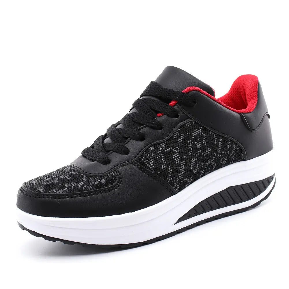 Black and red women’s platform sneaker with a textured mesh upper, leather accents, black laces, white rubber sole, and padded collar designed for sports and casual wear.