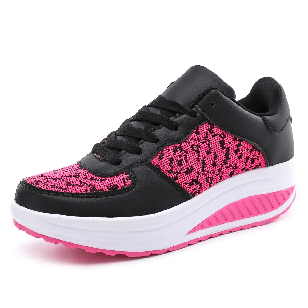 women’s platform sneakers featuring black and pink leather mesh with a textured knit panel, white midsole, and vibrant pink outsole designed for sports use