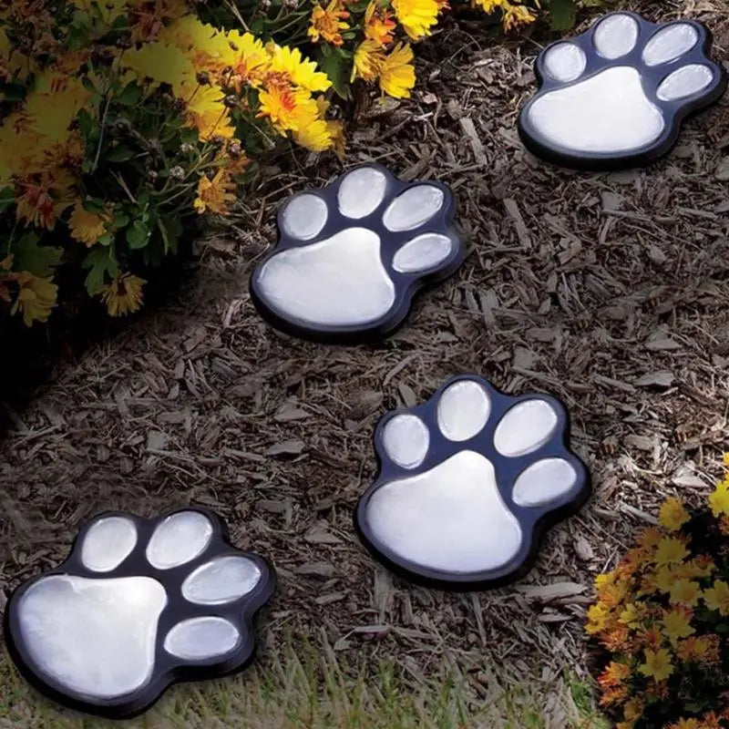 Schwarze und silberne, pfotenförmige Solar-Gartendekosteine mit LED-Lichtern für die Außendekoration von Gartenwegen.