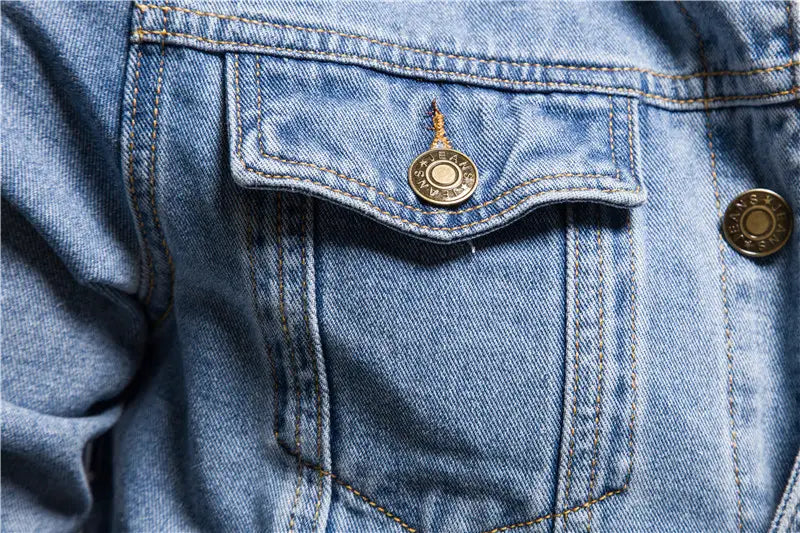 A gold-toned button with engraved text is featured on the pocket of a men light wash slim fit denim jacket.