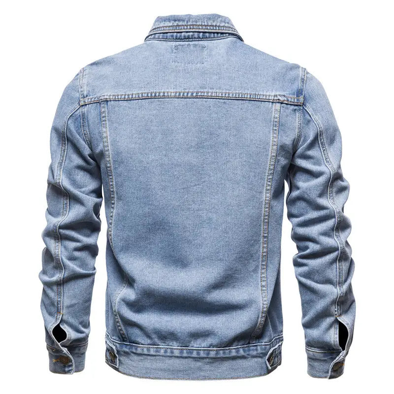 Men light wash slim fit denim jacket featuring classic stitching and buttoned cuffs made of durable denim material.