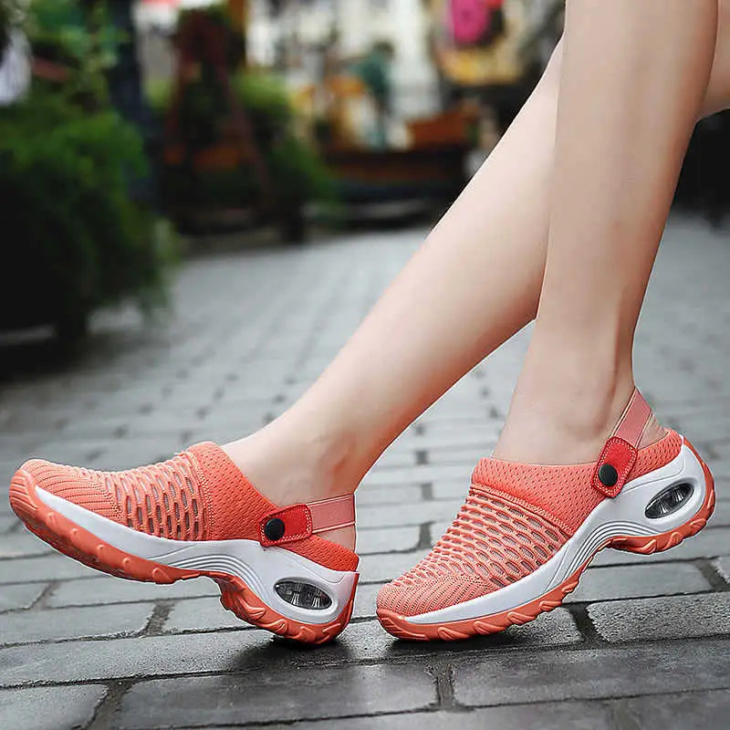 Coral-orange mesh air cushion clog sandals with breathable mesh material, white soles, and height increasing air cushioning units.