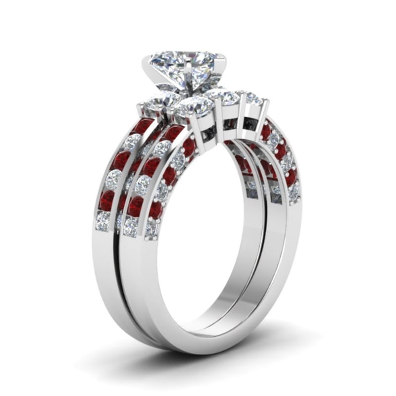 A sparkling diamond engagement ring with a central solitaire and side stones paired with an elegant white gold band featuring alternating red rubies and clear diamonds in the red wood and zircon inlay couple wedding ring set.