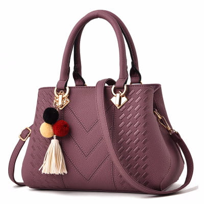 Purple luxury women handbag with chevron-patterned woven pu leather surface, gold-tone hardware accents, and a decorative pom-pom tassel charm.
