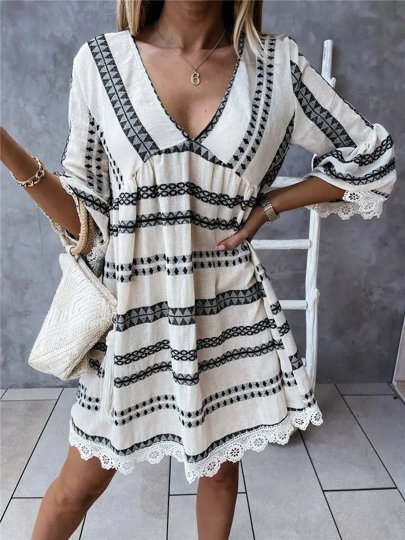 white and black embroidered boho geometric v-neck mini dress with lace trim at the hem and cuffs