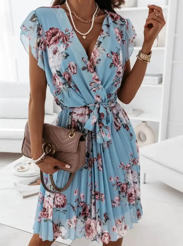 A light blue floral print wrap dress with ruffled short sleeves and a pleated skirt designed for elegant casual wear.