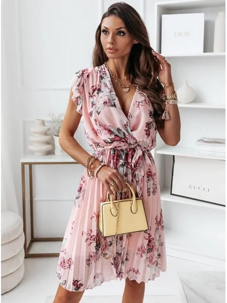 A soft pink floral print pleated midi dress with a v-neckline and ruffled short sleeves featuring a wrap design.