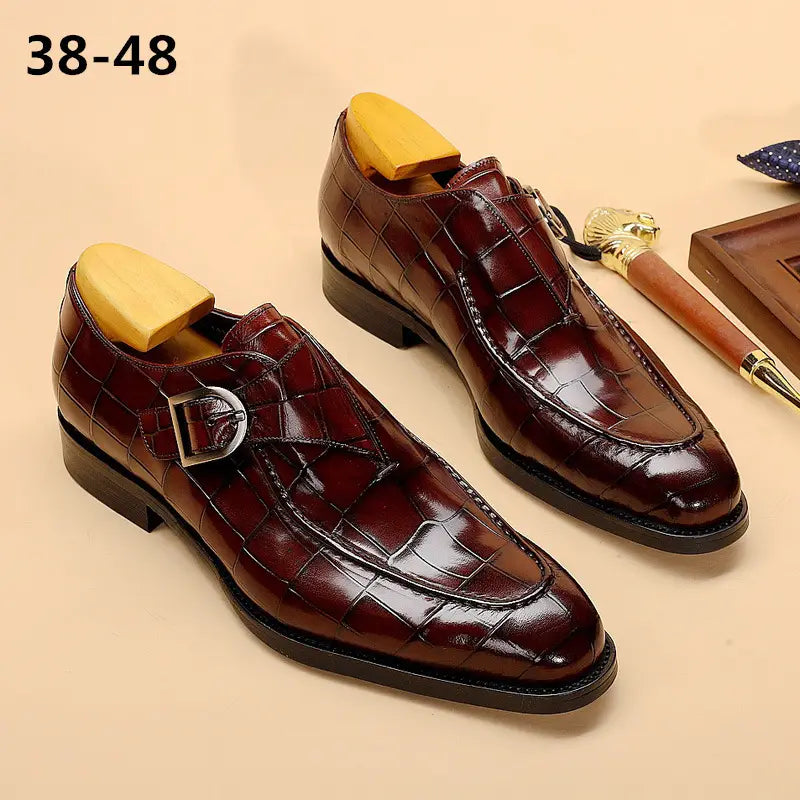 Classic men’s leather formal dress loafers in burgundy crocodile-embossed leather with silver monk strap buckle.