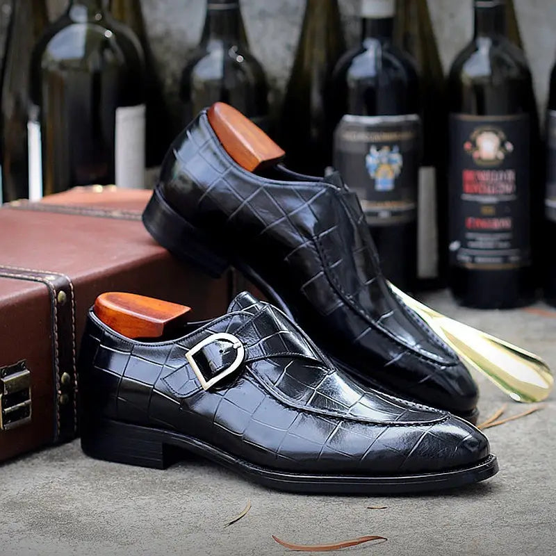 Classic men’s leather formal dress loafers in burgundy crocodile-embossed leather with silver monk strap buckle.
