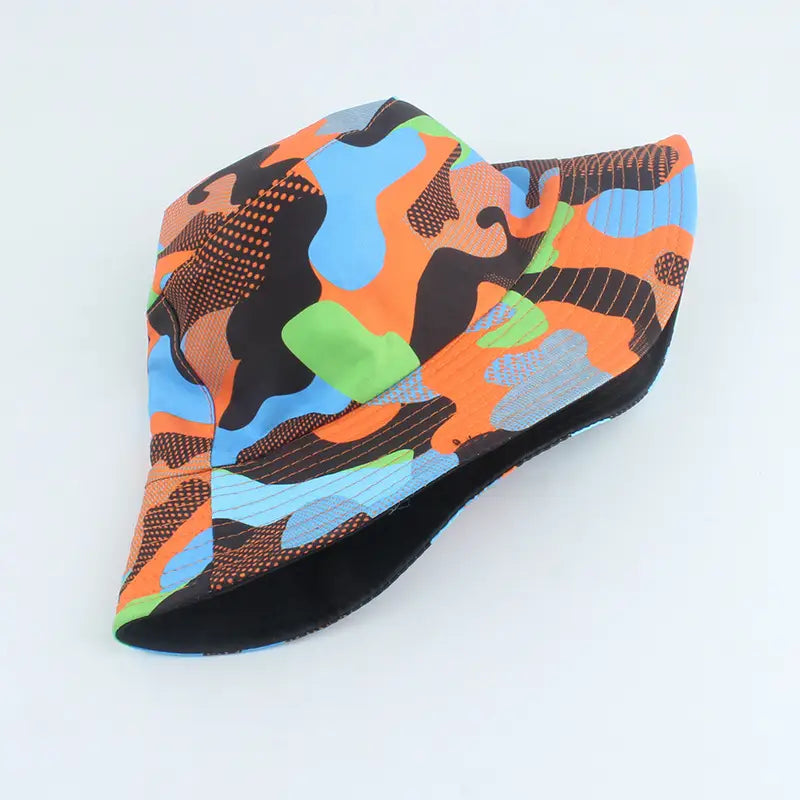A vibrant multicolored reversible camouflage fisherman hat with a bold orange blue green and black pattern and textured accents.