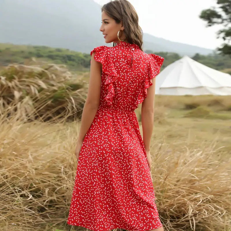 A vibrant red chiffon midi dress with delicate white floral patterns and ruffled shoulder details.