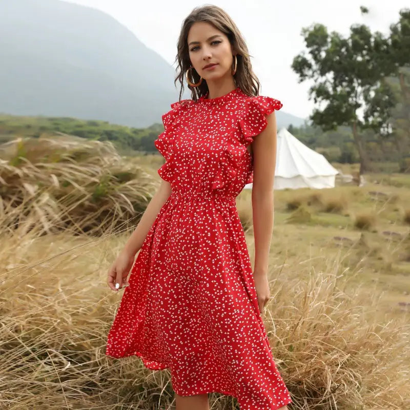 A vibrant red chiffon midi dress with delicate white floral patterns and ruffled short sleeves.