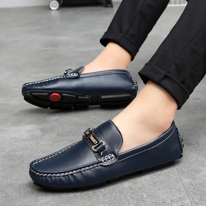 Navy blue leather men’s horsebit loafers with gold tone buckle white stitching and plush winter lining.