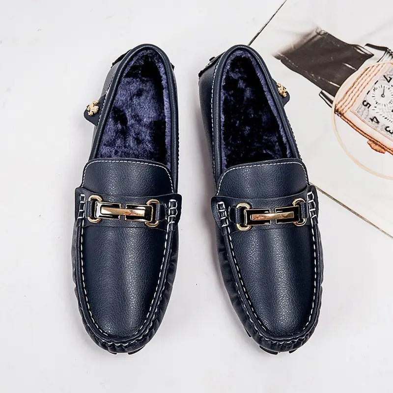 Navy blue leather men’s horsebit loafers with gold tone buckle white stitching and plush winter lining.