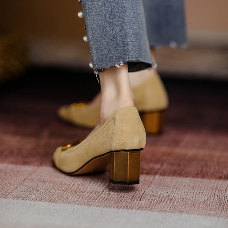 Beige suede square toe leather pumps with gold-toned block heel and decorative metal buckle detail.