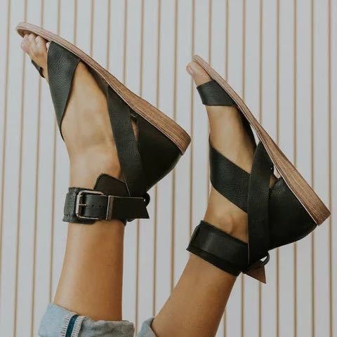 plus size women’s flat roman strappy sandals featuring black leather with woven straps and wooden soles