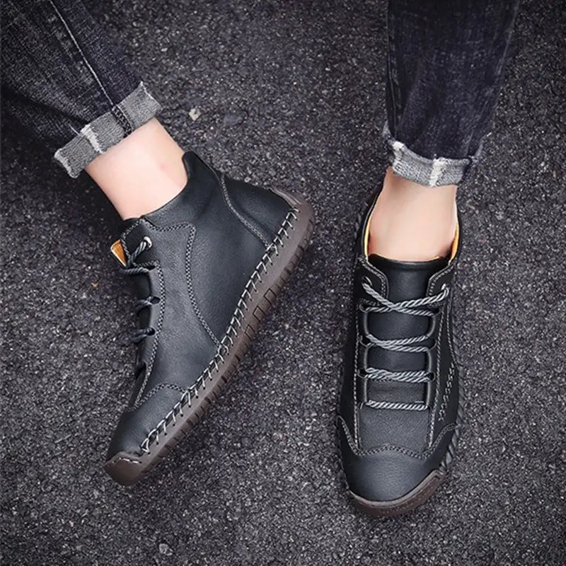Black leather ankle boots with hand stitched visible sole stitching and contrasting gray laces vintage high top sneakers.