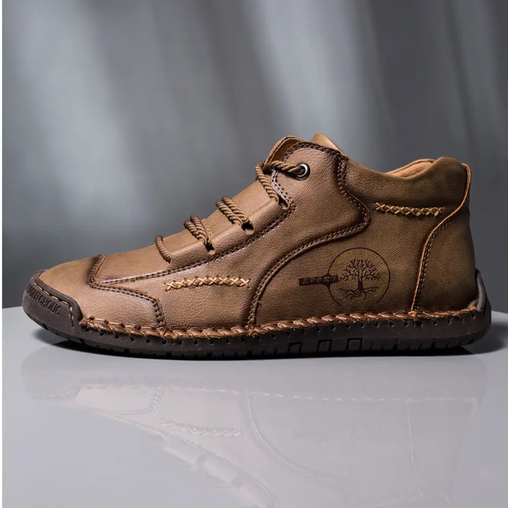 Tan leather ankle boot with braided laces and tree emblem hand stitched as a vintage high top sneaker.