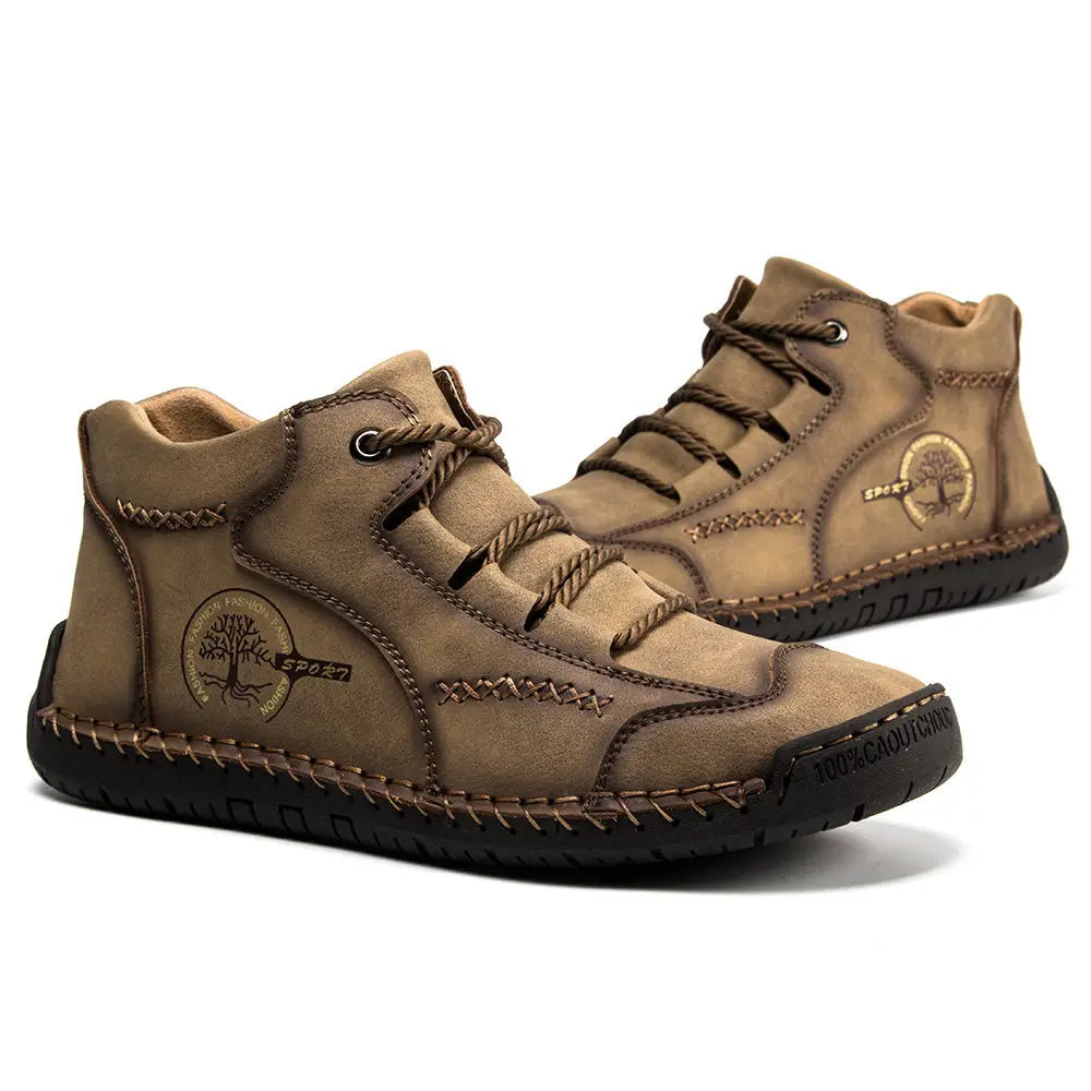 Leather boots hand stitched vintage high top sneakers in tan suede with brown laces, visible stitching, and a tree emblem patch on the side.
