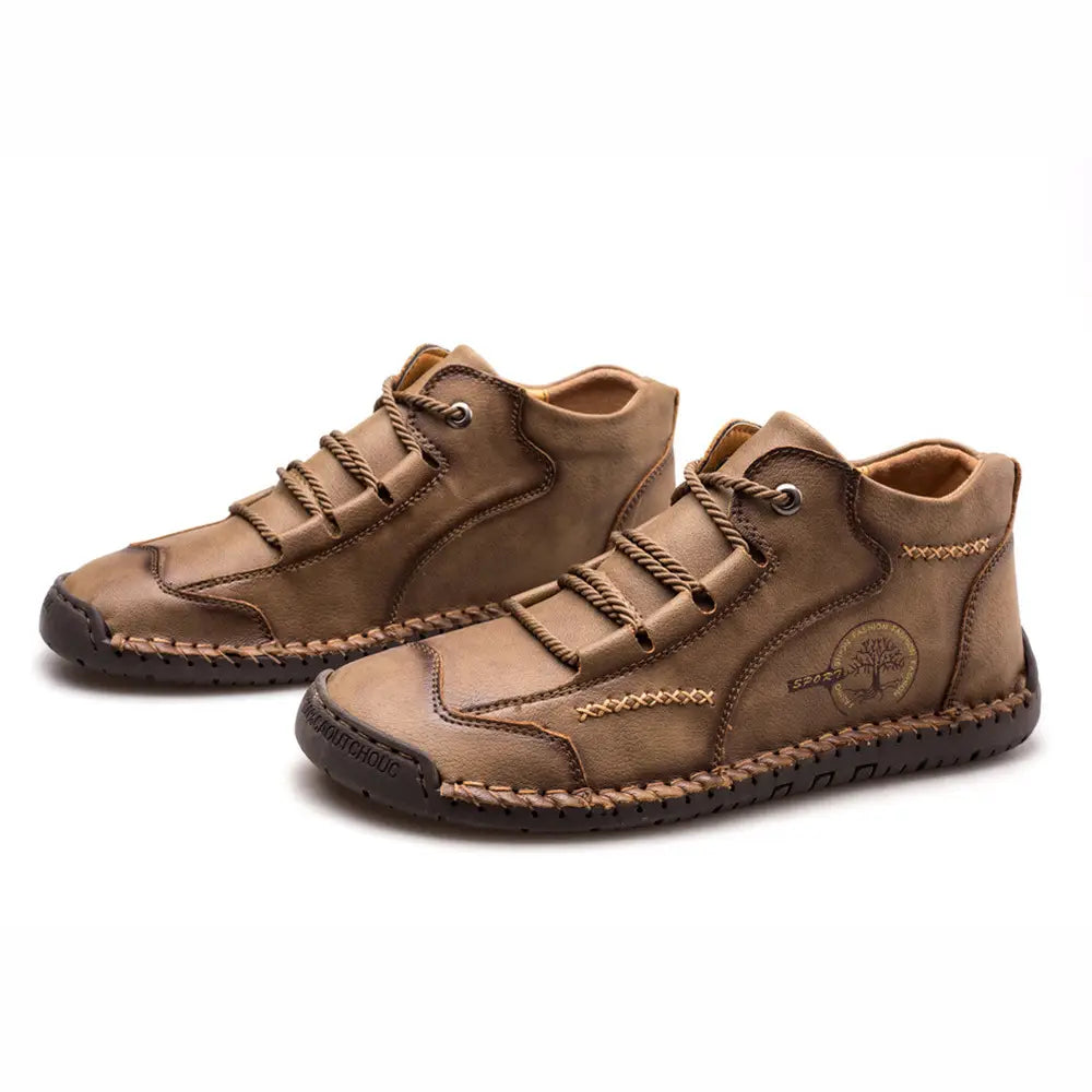 Brown leather lace-up ankle boots with visible stitching and a tree emblem on the side from the leather boots hand stitched vintage high top sneakers collection.