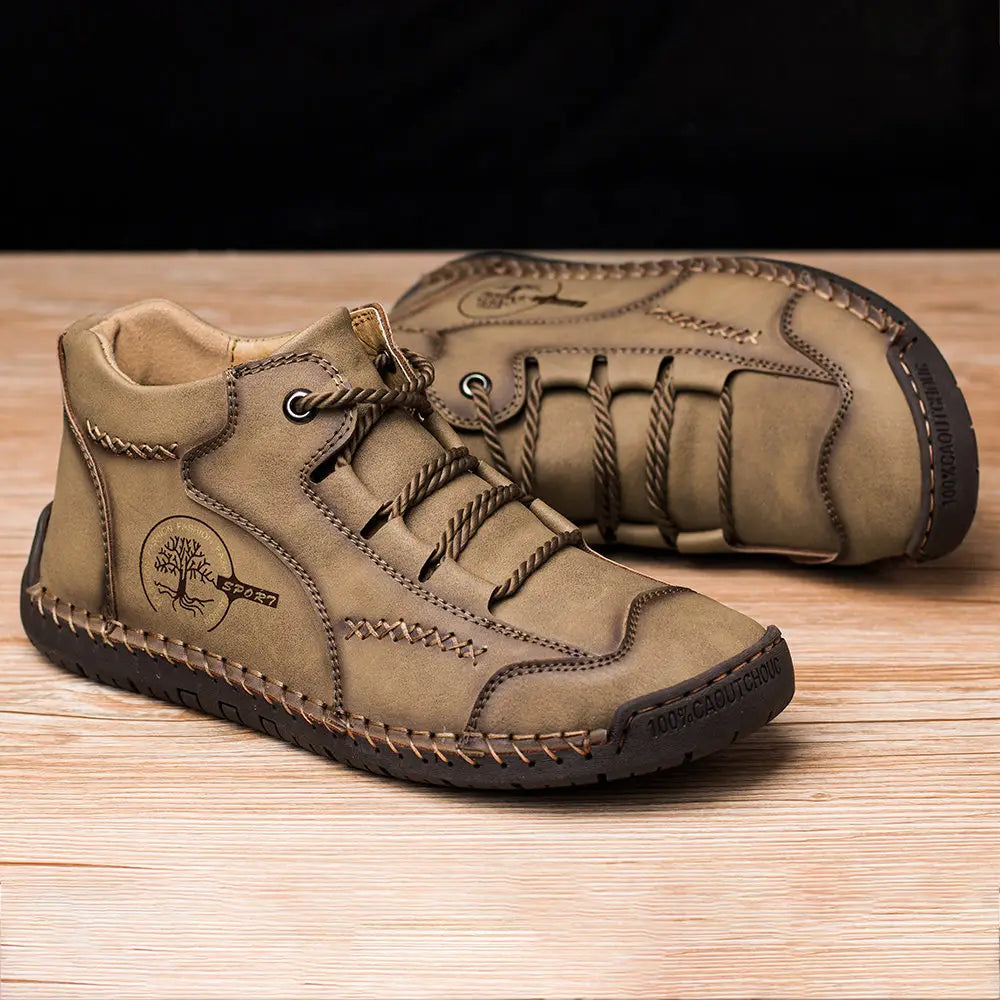 Leather boots hand stitched vintage high top sneakers in tan leather with braided laces and a tree emblem on the side.