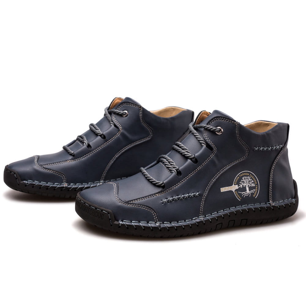 Dark blue leather hand stitched vintage high top sneakers with gray laces and a stitched tree emblem on the side.
