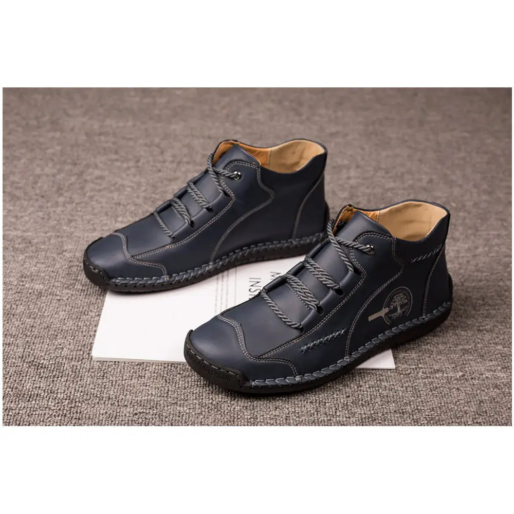 Black leather ankle boots with contrasting stitching and a subtle embroidered logo on the side from the leather boots hand stitched vintage high top sneakers collection.