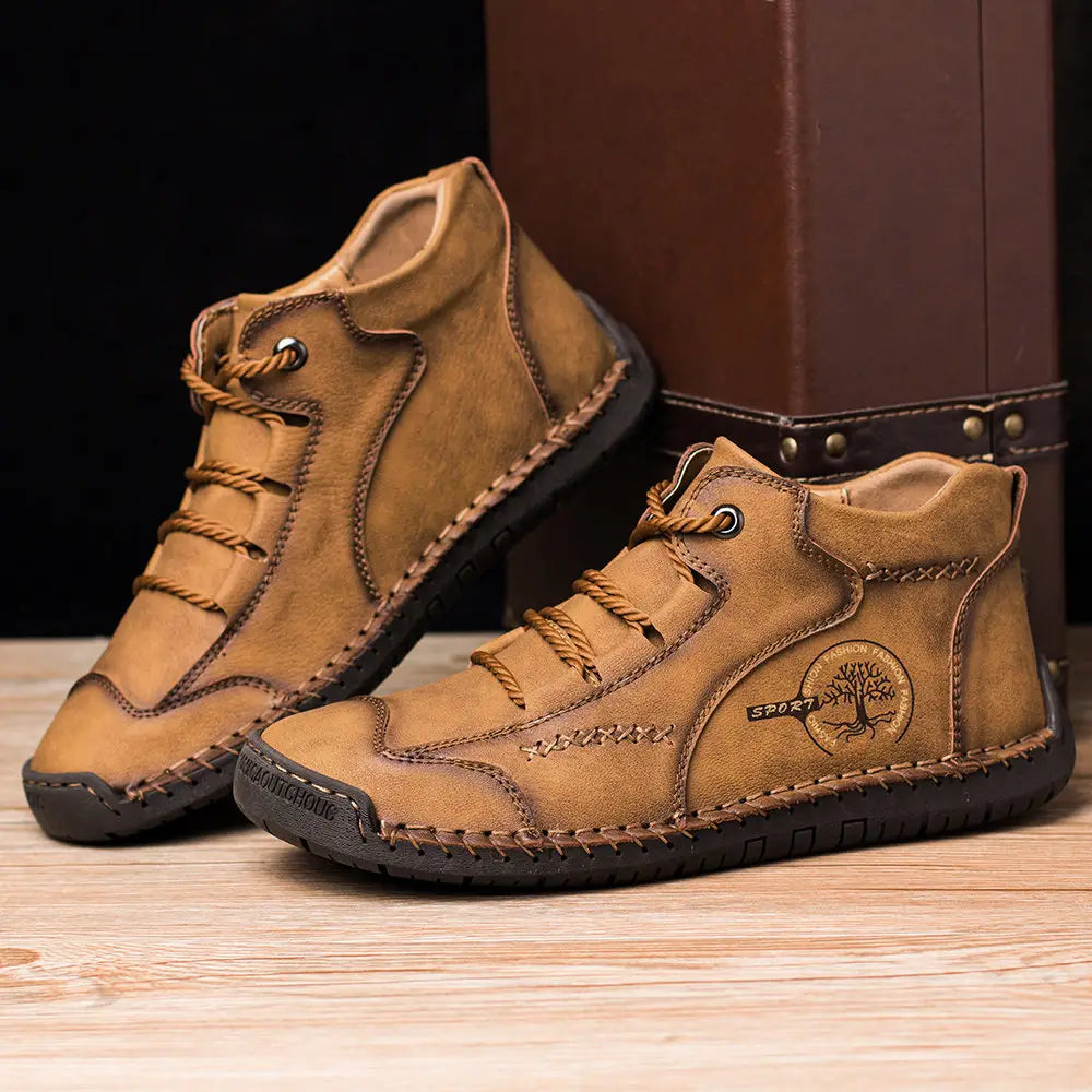 Tan leather hand stitched vintage high top sneakers featuring visible stitching and a tree logo on the side.