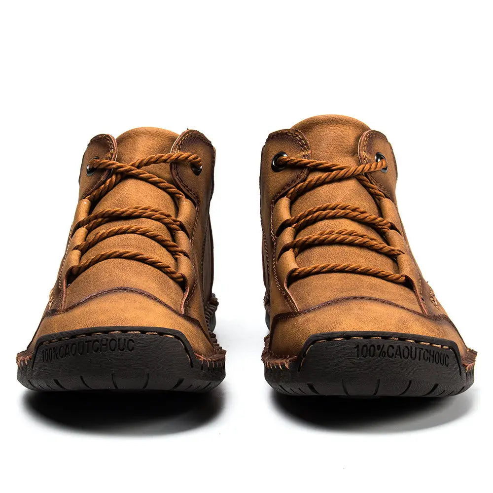 Leather boots hand stitched vintage high top sneakers in tan leather with brown braided laces and black rubber soles designed for men’s hiking.
