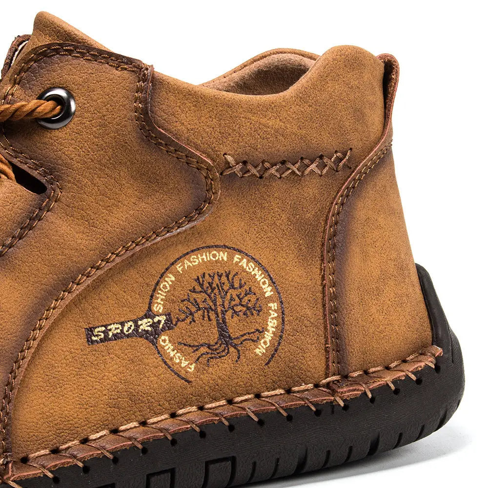 Tan suede leather boots hand stitched vintage high top sneakers with brown stitching and a circular logo featuring a tree design.