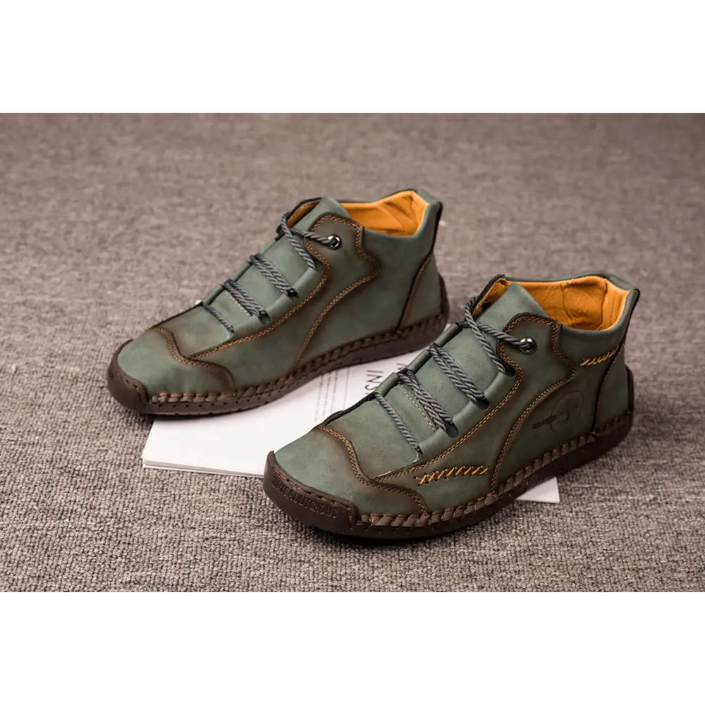 Olive green leather lace-up ankle boots with contrasting orange lining and brown stitching featured as hand stitched vintage high top sneakers.