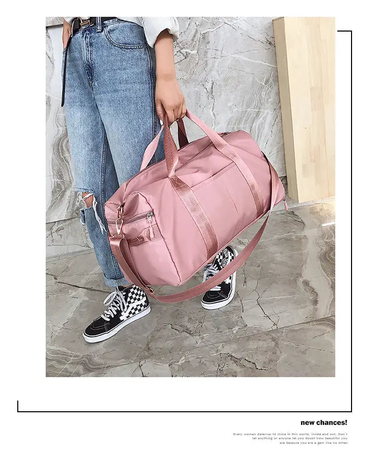 Rose gold nylon waterproof sports duffel bag in pink with matching handles and shoulder strap.