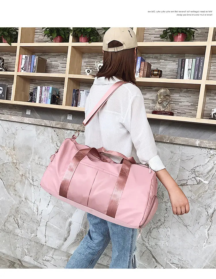 pink nylon waterproof sports duffel bag with rose gold accent straps designed for durability and style.